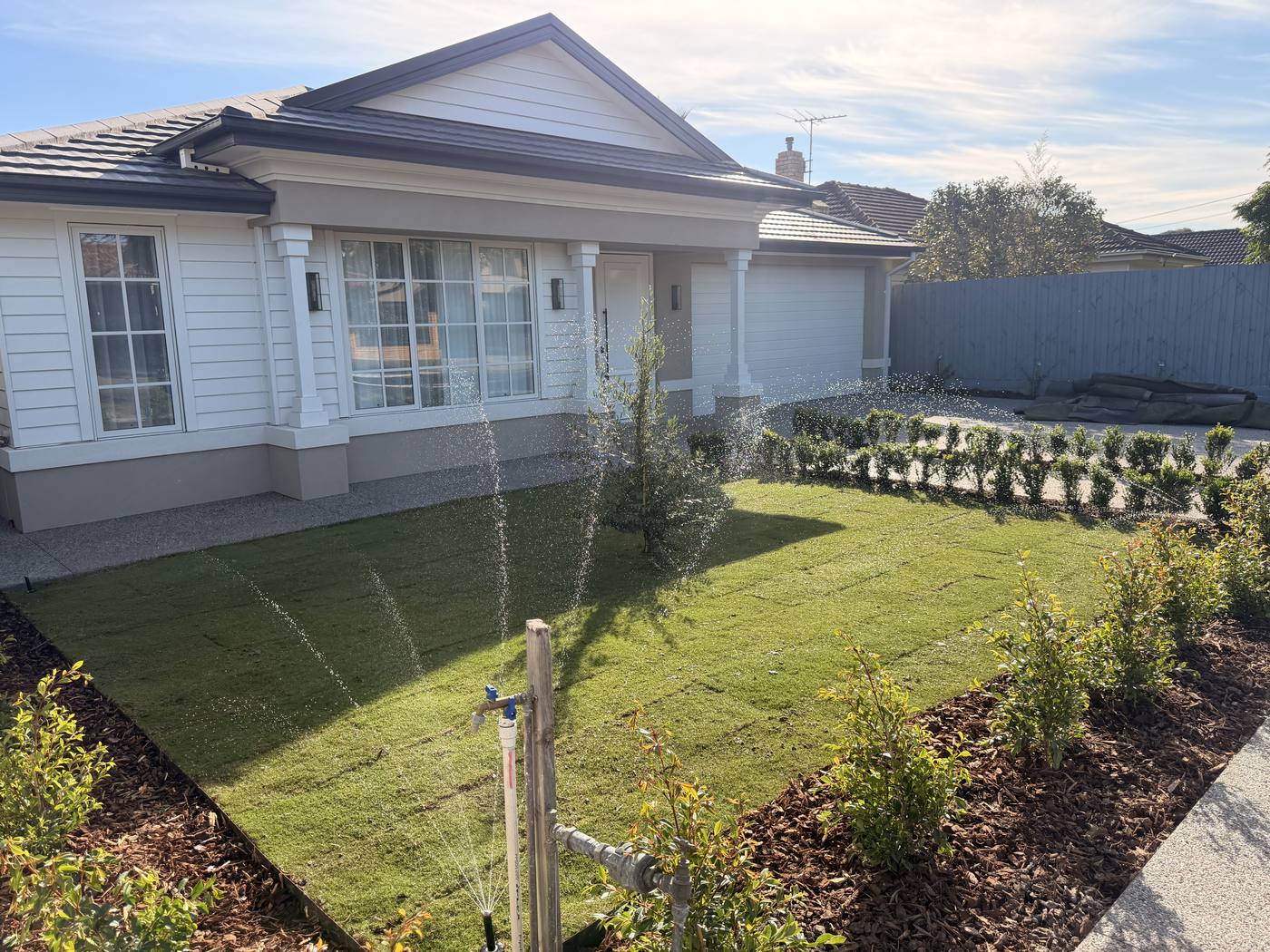 A single-storey premium home with a wide green lawn