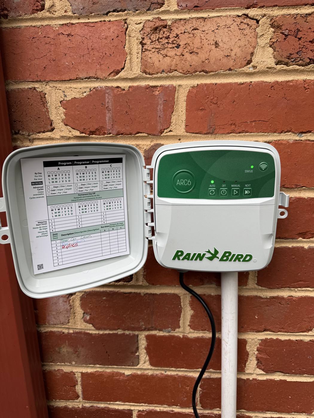 A Rain Bird controller cleanly mounted on a brick wall